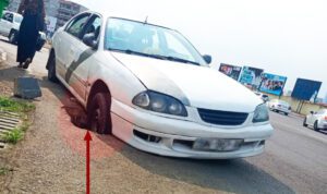 Un vehículo atrapado en un agujero ubicado en la carretera frente al campus central de la UNGE en Malabo.